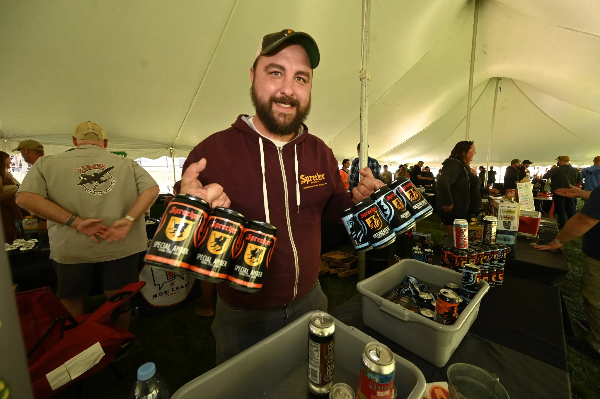 Sprecher vendor holding 2 craft beer 6-packs