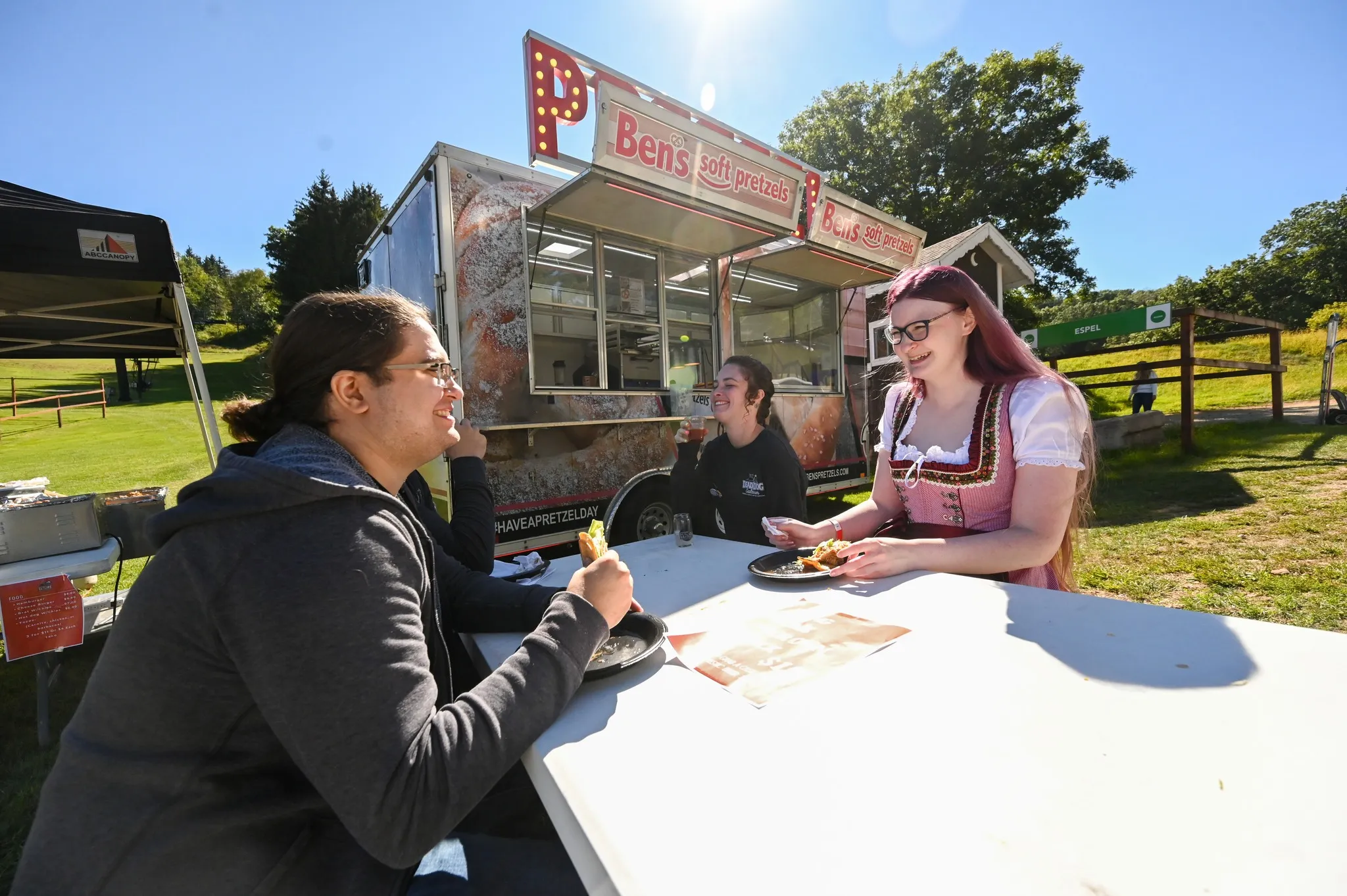 Guests enjoying a meal in front of food vendors